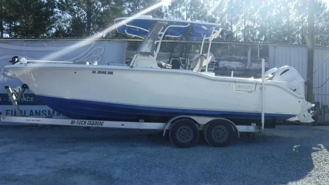 Slide: The Image of 2021 Key West 263FS boat on trailer, parked outdoors. - 2