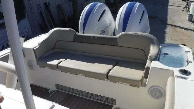 Slide: The Image of 2021 Key West 263FS boat with cushioned seating and dual outboard motors. - 21