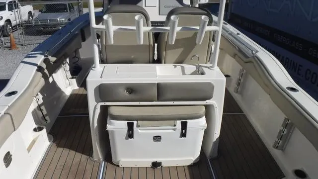 Slide: The Image of 2021 Key West 263FS boat interior with seating and cooler. - 23