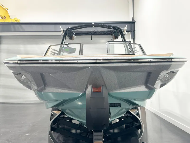 Slide: The Image of 2025 Centurion NV233 boat in showroom, front view, sleek design. - 4