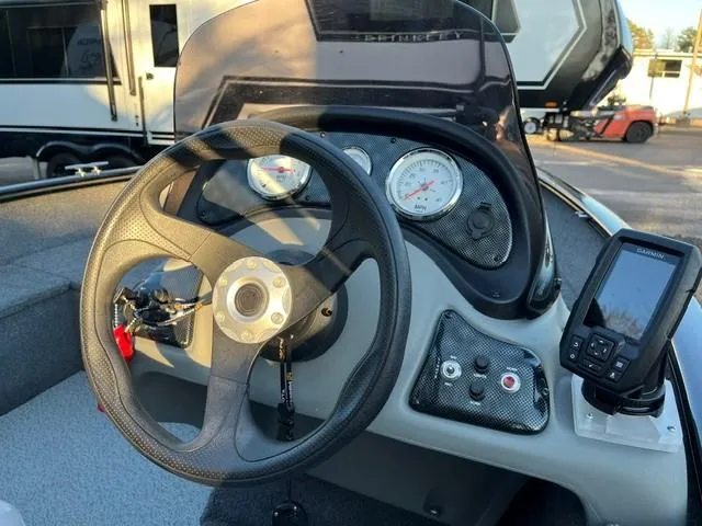 Slide: The Image of 2018 Tracker Pro Guide V-16 SC boat dashboard with steering wheel and gauges. - 3