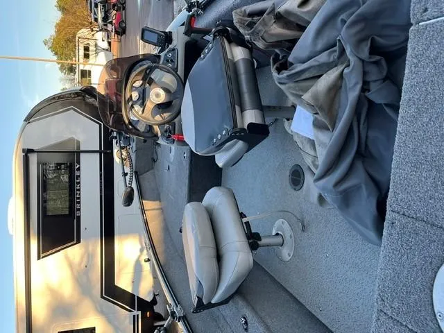 Slide: The Image of 2018 Tracker Pro Guide V-16 SC boat interior with seats and steering wheel. - 7