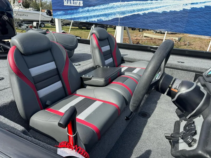 Slide: The Image of 2025 Ranger RT188C boat interior with gray and red seats, steering wheel, and control panel. - 3