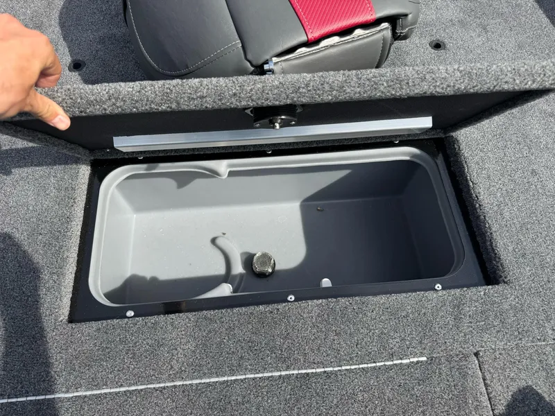 Slide: The Image of 2025 Ranger RT188C boat storage compartment with open lid, gray interior, and red seat detail. - 5