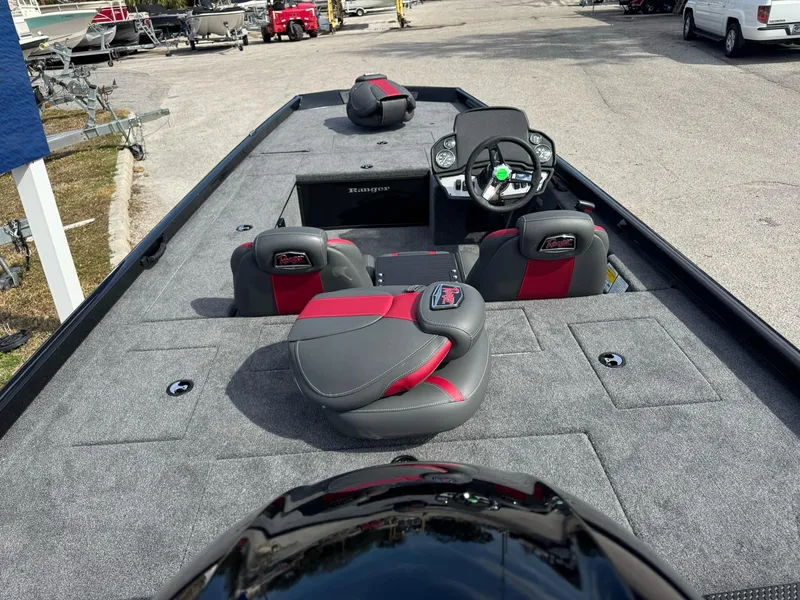 Slide: The Image of 2025 Ranger RT188C boat interior with gray and red seating, steering console, and spacious deck. - 7