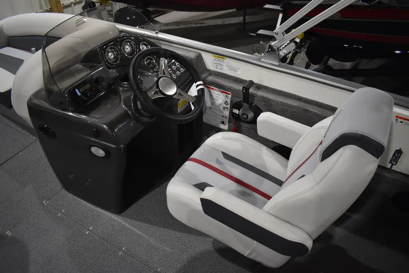 Slide: The Image of 2025 Lowe SD224 Sport Deck boat interior with steering console and captain's chair. - 10