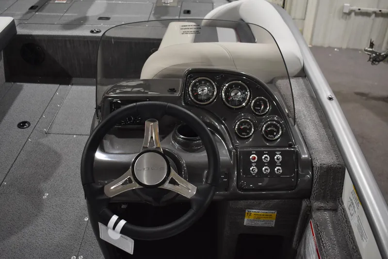 Slide: The Image of 2025 Lowe SD224 Sport Deck boat dashboard with steering wheel and instrument panel. - 11