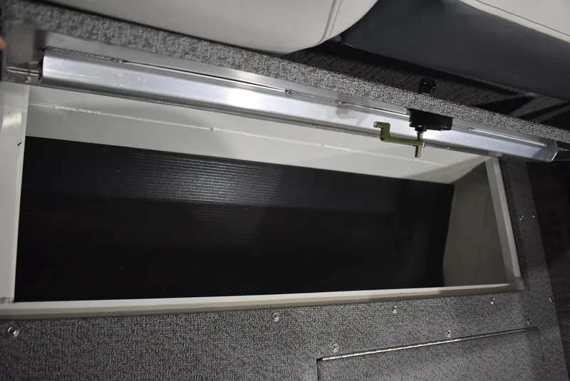 Slide: The Image of 2025 Lowe SD224 Sport Deck storage compartment, open and empty, with gray interior. - 16