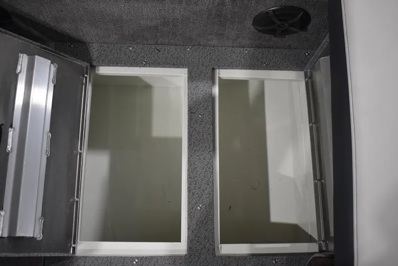 Slide: The Image of 2025 Lowe SD224 Sport Deck storage compartments with open lids, showcasing interior space. - 17