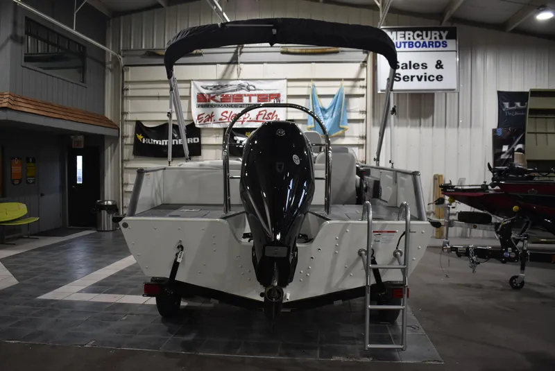 Slide: The Image of 2025 Lowe SD224 Sport Deck boat displayed in indoor showroom. - 2