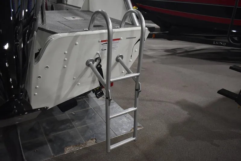 Slide: The Image of 2025 Lowe SD224 Sport Deck boat with a foldable ladder on display. - 4