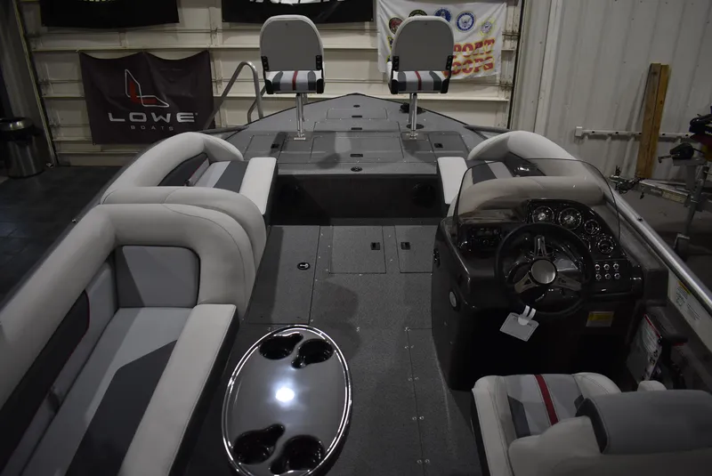 Slide: The Image of 2025 Lowe SD224 Sport Deck boat interior with seating and control panel. - 5