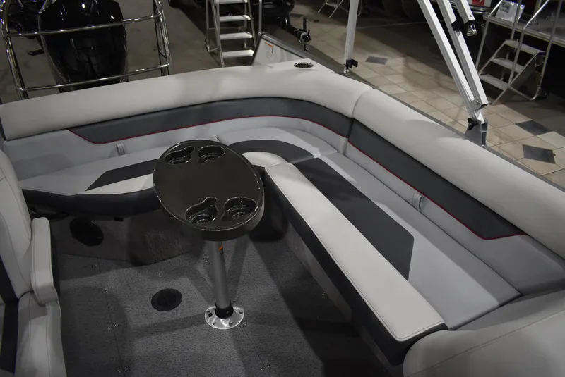 Slide: The Image of 2025 Lowe SD224 Sport Deck interior with gray seating and a central table. - 7
