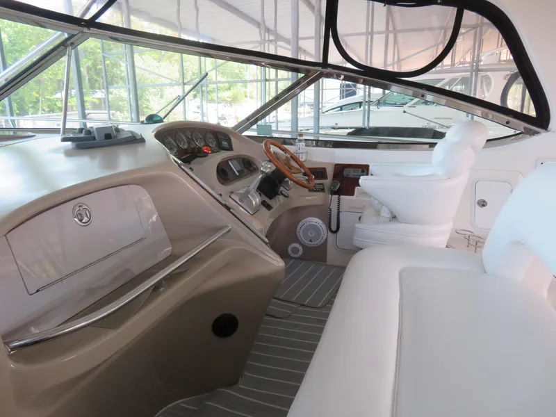 Slide: The Image of Interior of 2001 Sea Ray 510DA yacht with helm, steering wheel, and seating. - 10