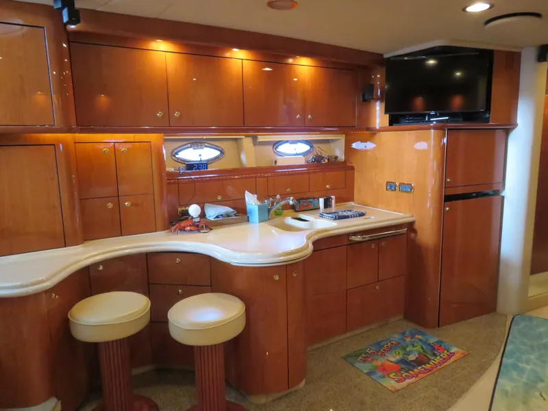 Slide: The Image of Luxurious 2001 Sea Ray 510DA yacht interior with elegant wood cabinetry and modern amenities. - 15