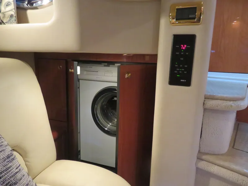 Slide: The Image of Interior of 2001 Sea Ray 510DA yacht featuring a built-in washing machine. - 24