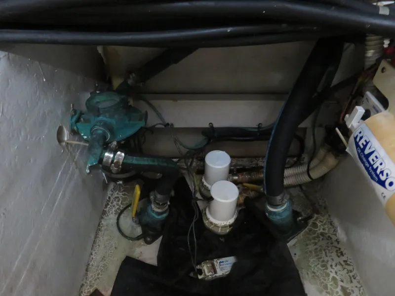 Slide: The Image of Engine compartment of a 2001 Sea Ray 510DA with visible hoses and components. - 26