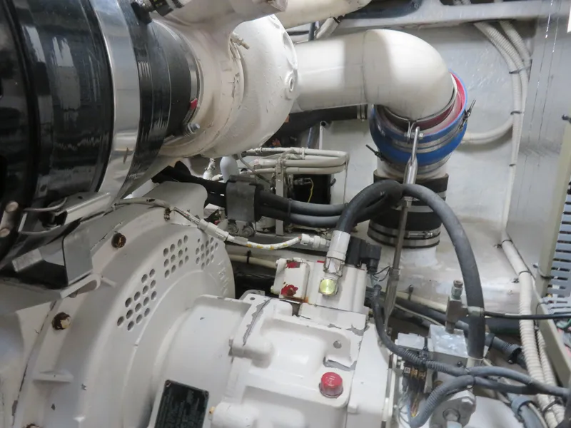 Slide: The Image of Engine room of 2001 Sea Ray 510DA yacht, showcasing mechanical components and piping. - 28