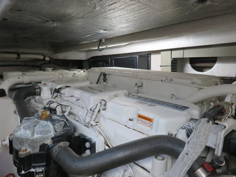Slide: The Image of Engine room of a 2001 Sea Ray 510DA yacht, showcasing mechanical components and wiring. - 29