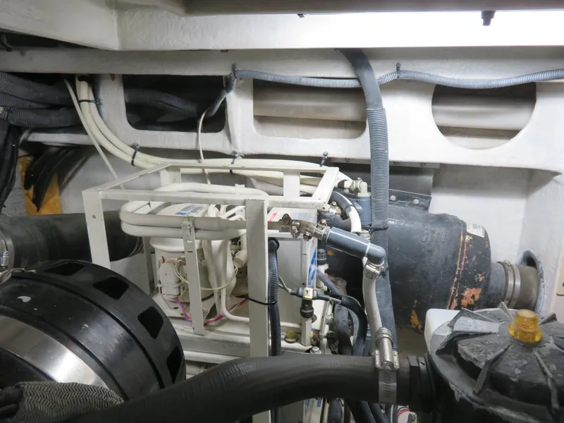 Slide: The Image of Engine room of a 2001 Sea Ray 510DA yacht, showcasing mechanical components and wiring. - 32