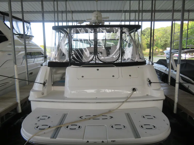 Slide: The Image of 2001 Sea Ray 510DA yacht docked in a covered marina, rear view. - 5
