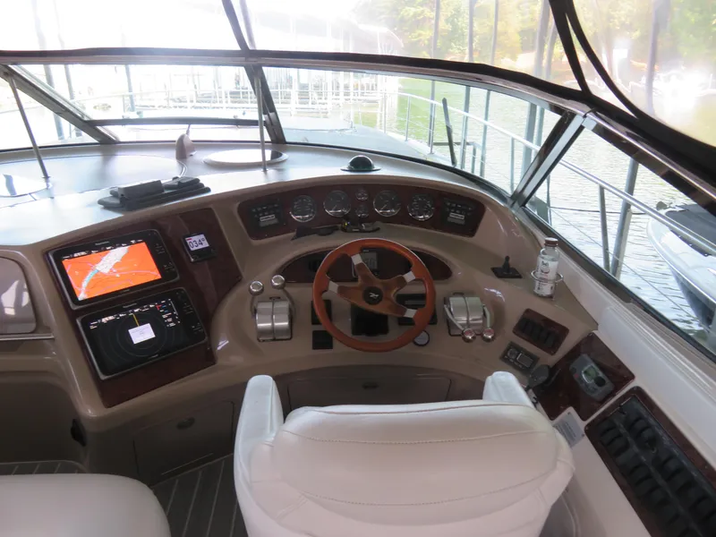 Slide: The Image of Helm of 2001 Sea Ray 510DA yacht with navigation equipment and steering wheel. - 8
