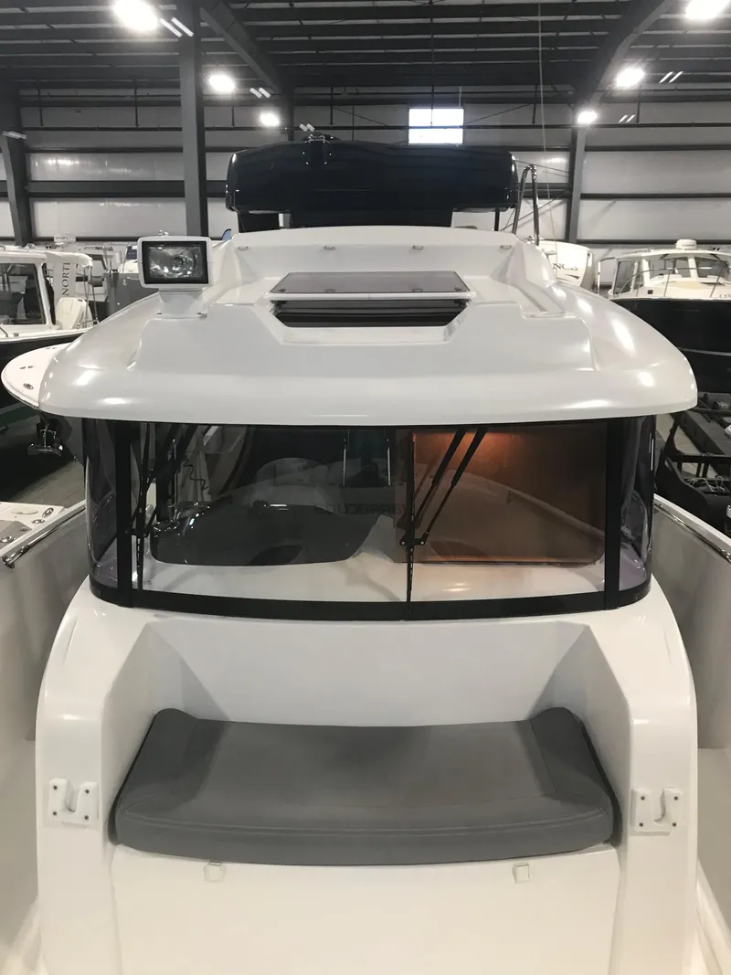 Slide: The Image of 2013 Beneteau Barracuda 9 boat in indoor showroom, front view. - 11