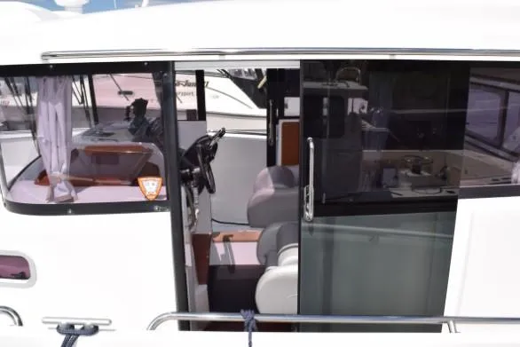 Slide: The Image of 2013 Beneteau Barracuda 9 boat interior with steering wheel and seating. - 12