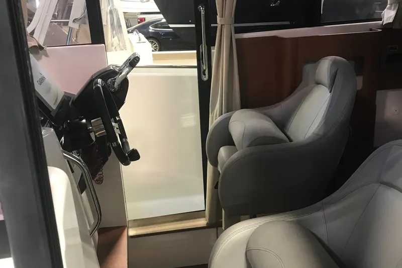 Slide: The Image of Interior of 2013 Beneteau Barracuda 9 boat with steering wheel and seats. - 13