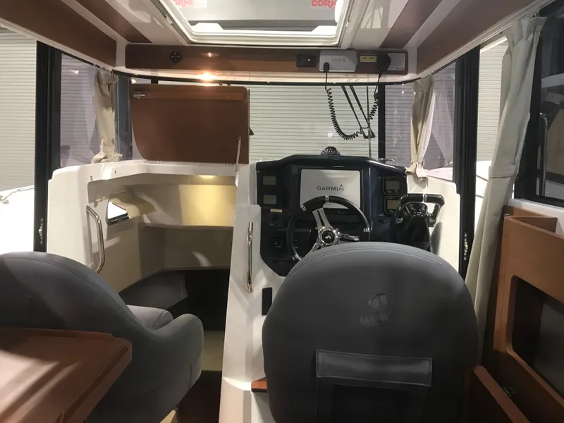 Slide: The Image of Interior of 2013 Beneteau Barracuda 9 boat, featuring helm and seating area. - 14