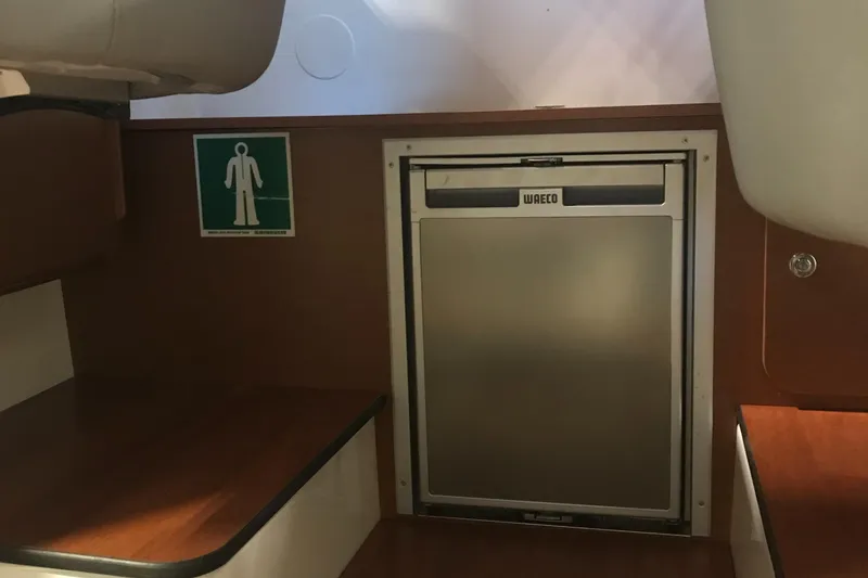 Slide: The Image of Interior of 2013 Beneteau Barracuda 9 with WAECO fridge and wooden cabinetry. - 17