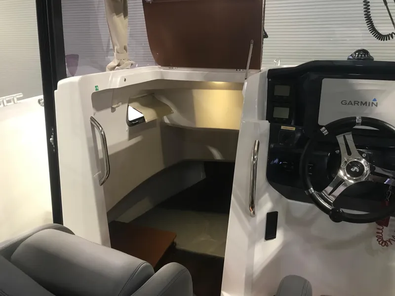 Slide: The Image of Interior view of 2013 Beneteau Barracuda 9 boat with steering wheel and cabin area. - 18