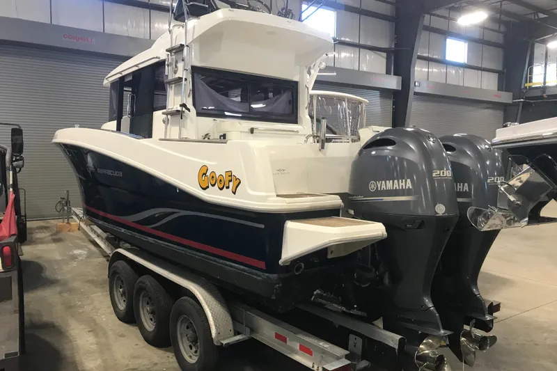 Slide: The Image of 2013 Beneteau Barracuda 9 boat with twin Yamaha engines on a trailer. - 2