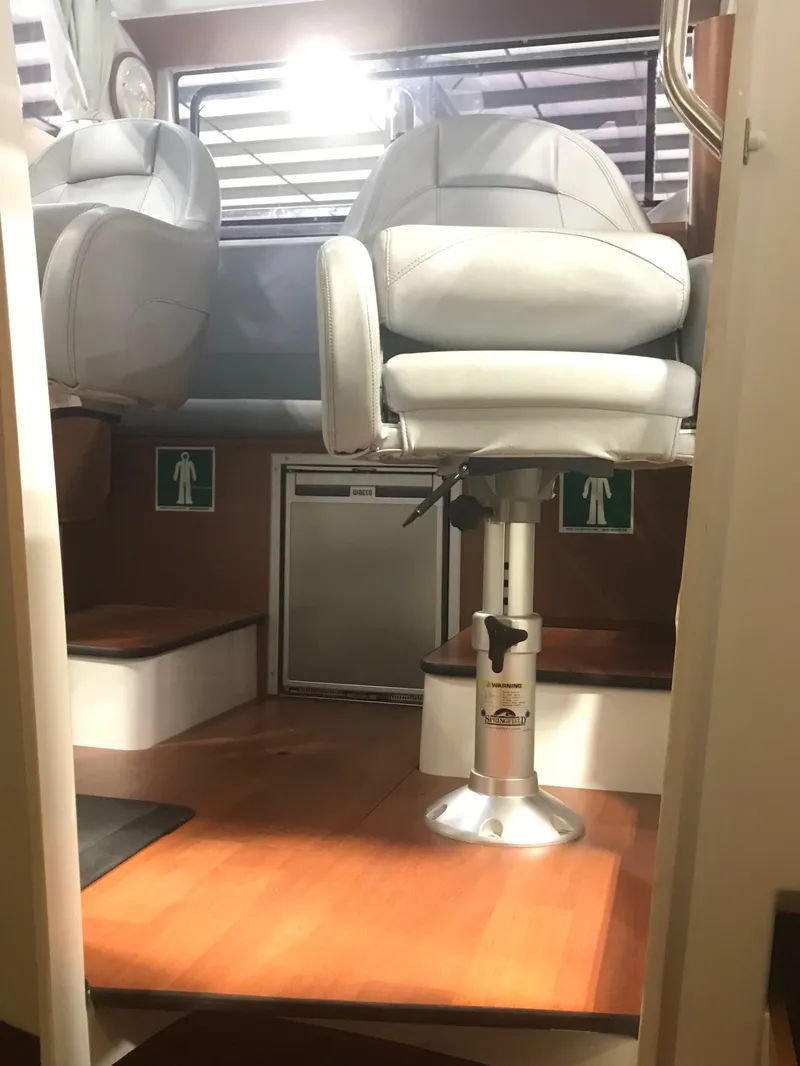 Slide: The Image of Interior of a 2013 Beneteau Barracuda 9 boat with seating and wooden flooring. - 21