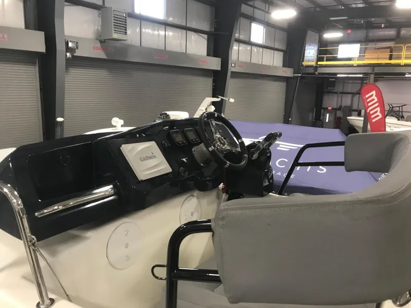 Slide: The Image of 2013 Beneteau Barracuda 9 boat interior with steering wheel and navigation equipment. - 23