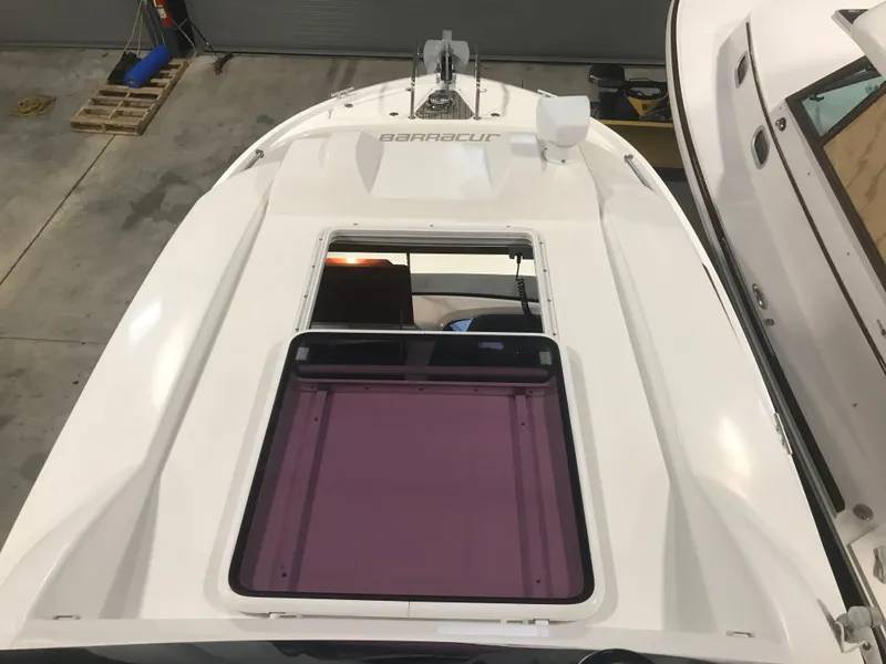 Slide: The Image of 2013 Beneteau Barracuda 9 boat, top view, in a garage setting. - 25