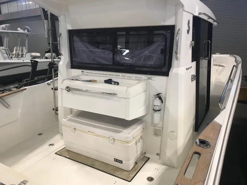 Slide: The Image of 2013 Beneteau Barracuda 9 boat interior with storage and seating area. - 4