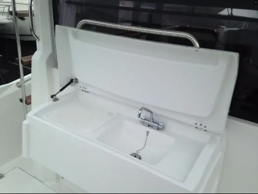 Slide: The Image of 2013 Beneteau Barracuda 9 boat sink with open lid and faucet. - 5