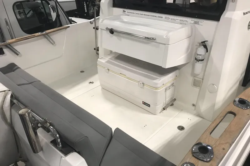 Slide: The Image of 2013 Beneteau Barracuda 9 boat interior with seating and storage area. - 6