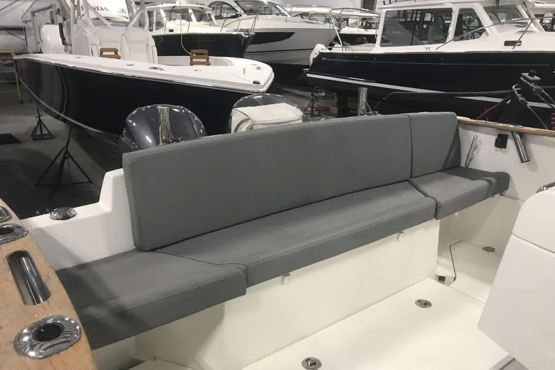 Slide: The Image of 2013 Beneteau Barracuda 9 boat interior with gray seating in a showroom. - 7