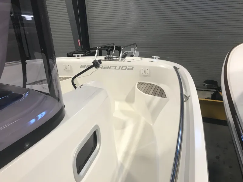 Slide: The Image of 2013 Beneteau Barracuda 9 boat, white exterior, docked indoors. - 8