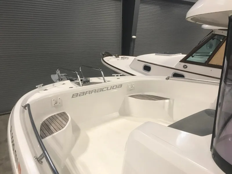 Slide: The Image of 2013 Beneteau Barracuda 9 boat interior, showcasing sleek design and spacious seating. - 9