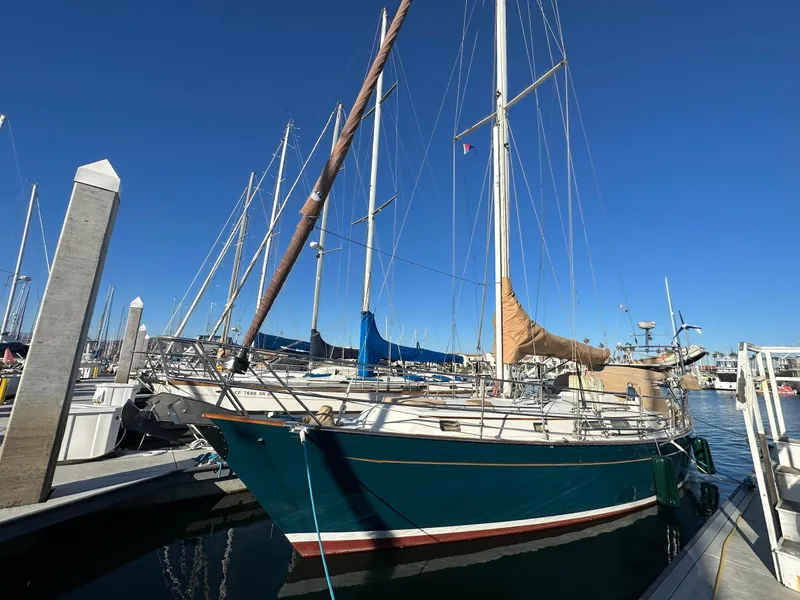 Slide: The Image of Sailboat docked at marina, Passport Royal 43, 1999 model, under clear blue sky. - 2