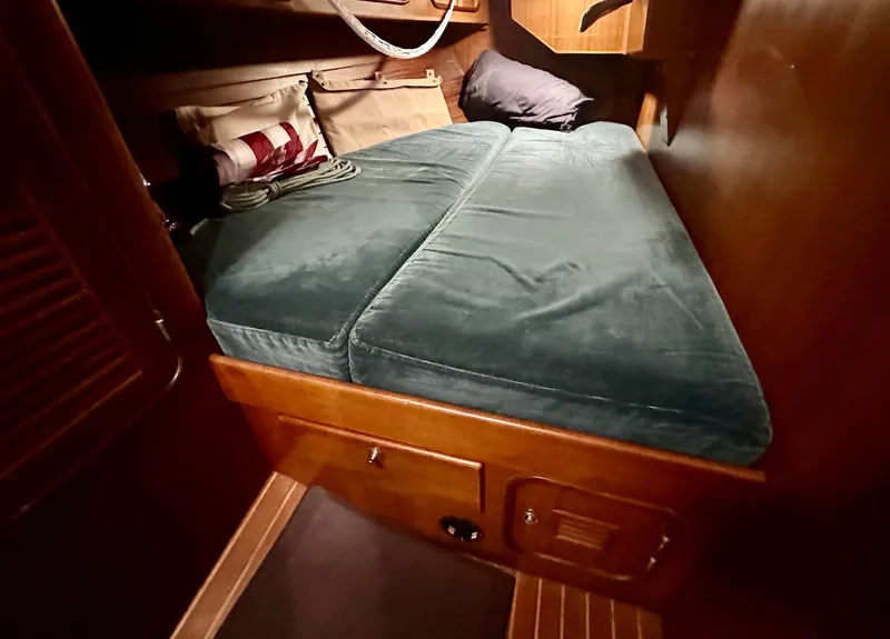 Slide: The Image of Cozy cabin bed in 1999 Passport Royal 43 sailboat with green cushions. - 20
