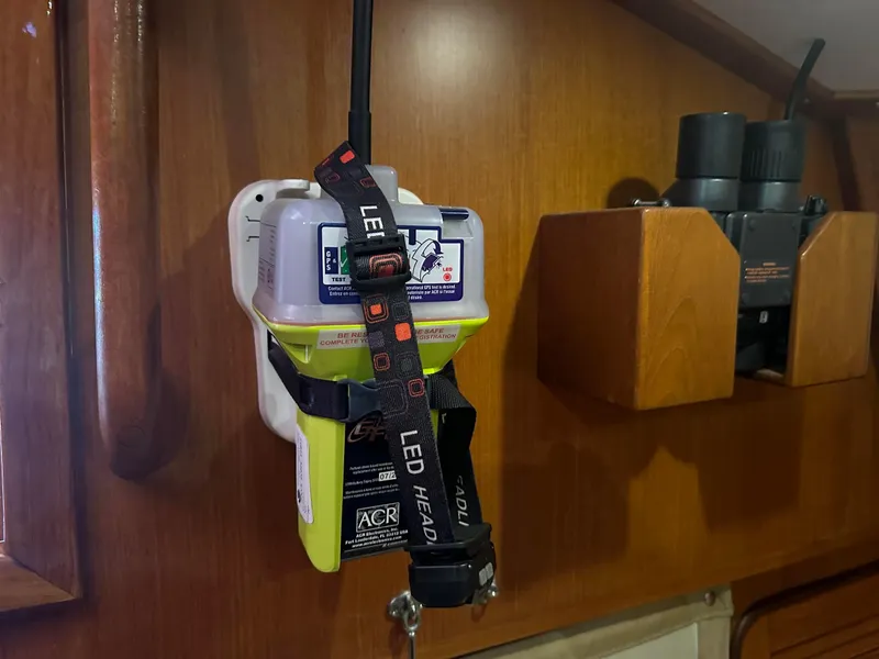 Slide: The Image of Emergency locator beacon mounted on a wooden wall inside a 1999 Passport Royal 43 boat. - 21