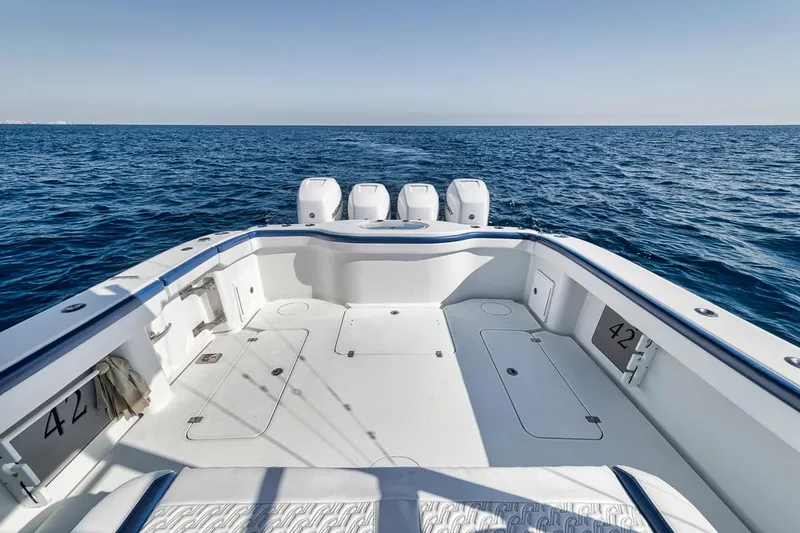 Slide: The Image of 2020 Yellowfin 42 Offshore boat on open sea, showcasing spacious deck and triple engines. - 12