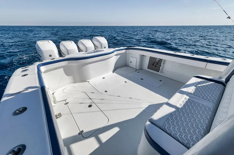 Slide: The Image of 2020 Yellowfin 42 Offshore boat with spacious deck and four engines on open sea. - 13