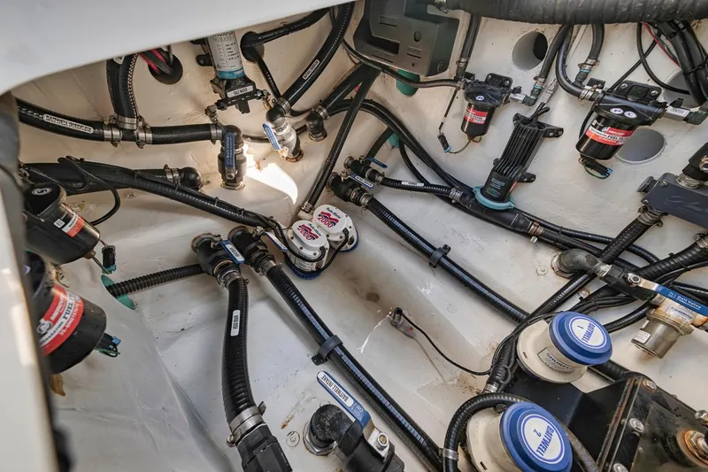 Slide: The Image of Engine compartment of a 2020 Yellowfin 42 Offshore boat, showcasing intricate wiring and components. - 18