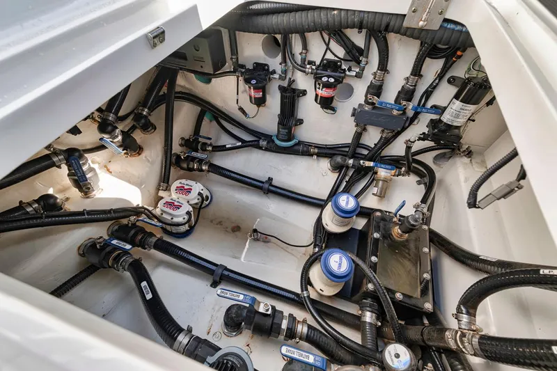Slide: The Image of 2020 Yellowfin 42 Offshore boat engine compartment with complex wiring and plumbing systems. - 19
