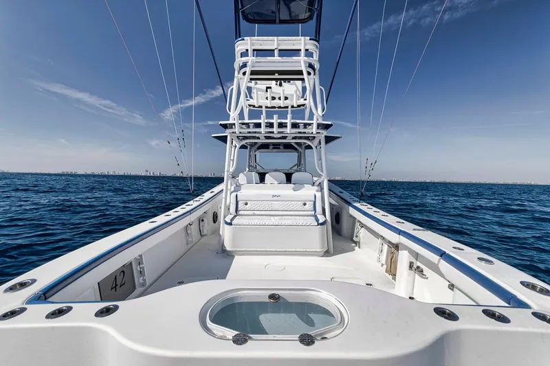 Slide: The Image of 2020 Yellowfin 42 Offshore boat on open sea, clear sky, fishing setup. - 25